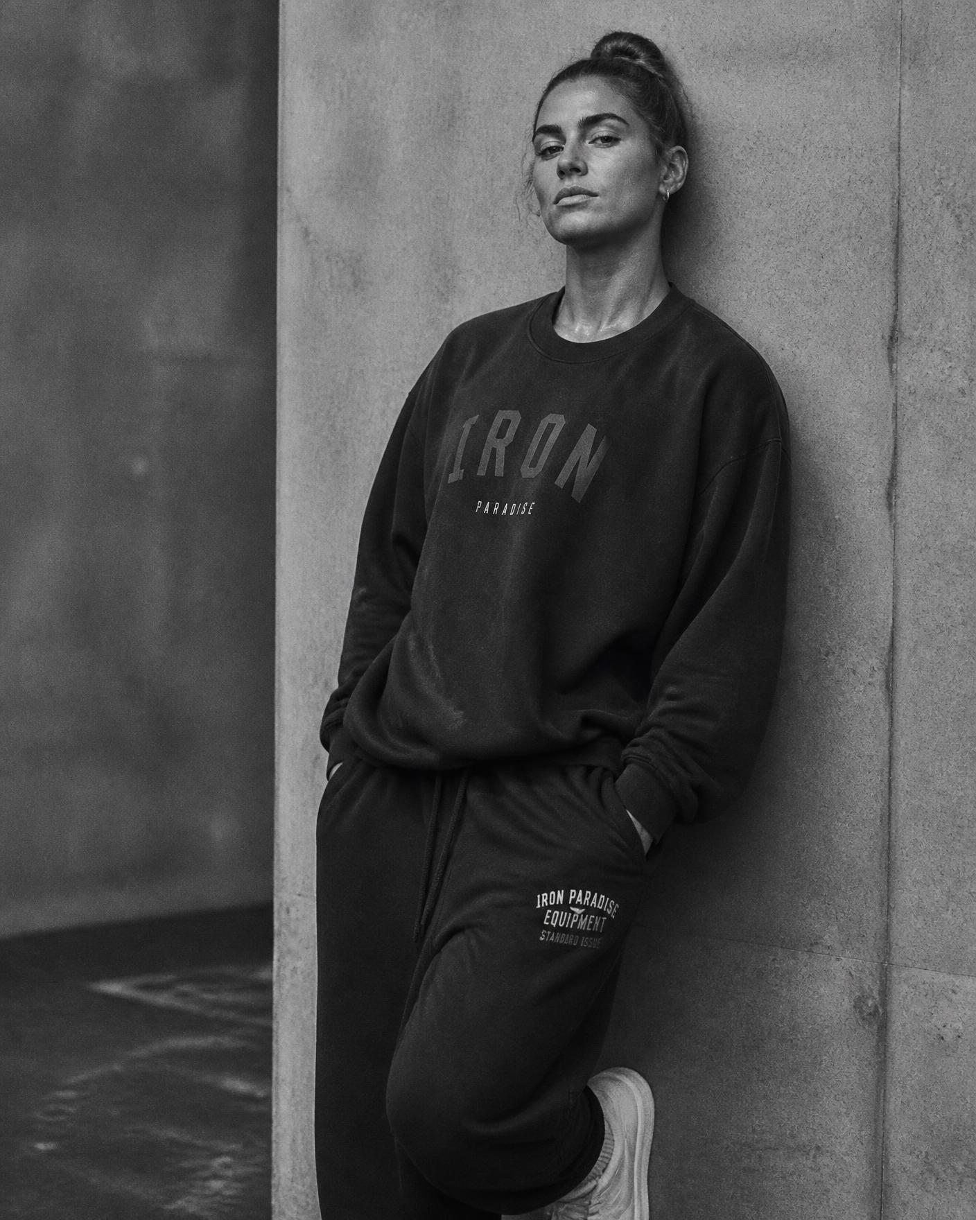 Editorial portrait of a woman in oversized gym streetwear